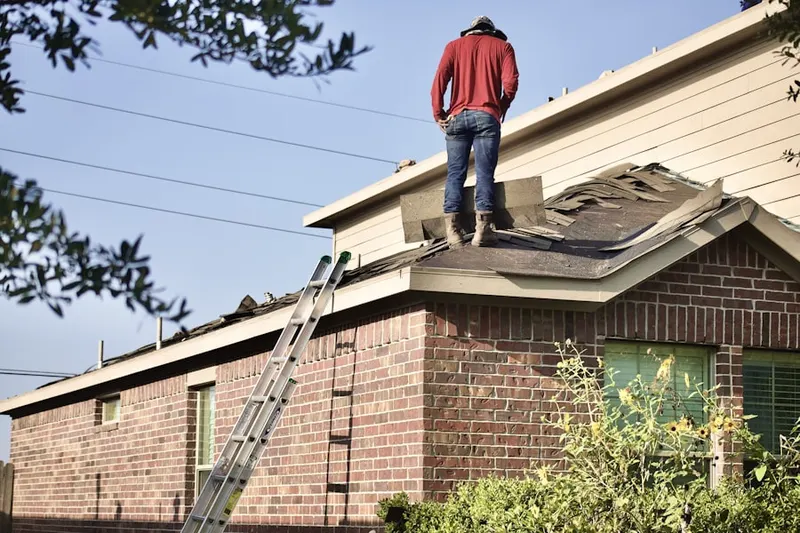 Professional roofer working on a residential roof in New Bethel